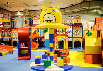 Modern children playground indoor with lot of colorful toys and obstacles