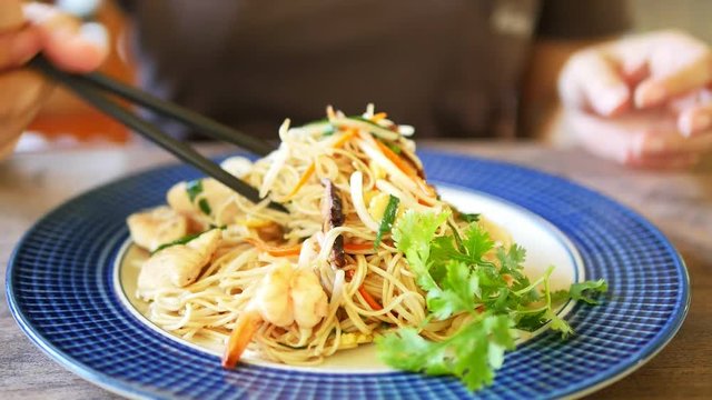 Close up of woman eating Thai Asian food - Asian food eating concept