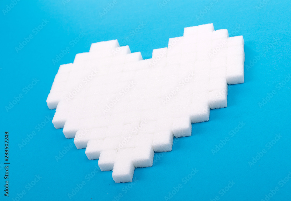 Wall mural Heart of sugar cubes, blue background