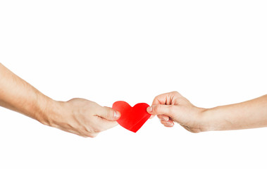 Fototapeta premium Hands of people hold red heart. Valentines day relationship concept. On isolated background