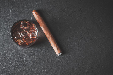 Whiskey with ice and cigar. Copy space 