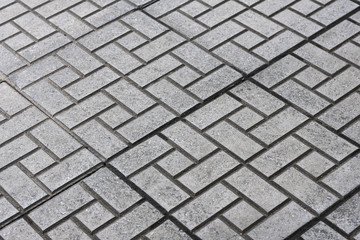 Grey brick block on footpath.