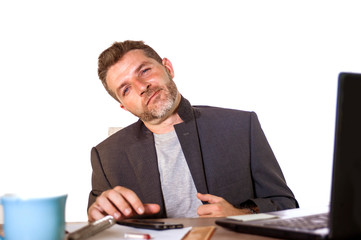 isolated portrait of young successful and attractive businessman working at office computer desk satisfied and relaxed in financial business success