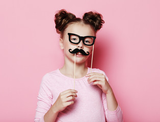 Girl pose with photo booth props glasses and mustache.