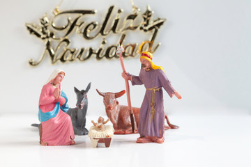 Christmas Manger scene with Jesus, Mary and Joseph and feliz navidad