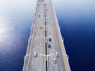 Aerial view of highway in the ocean. Cars crossing bridge interchange overpass. Highway interchange...