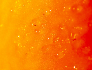 Drops of juice on pumpkin pulp as abstract background
