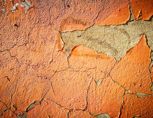 Old cracked wall with orange paint as background