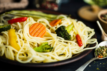 pasta with fried vegetables and spices and seasoning on a plate