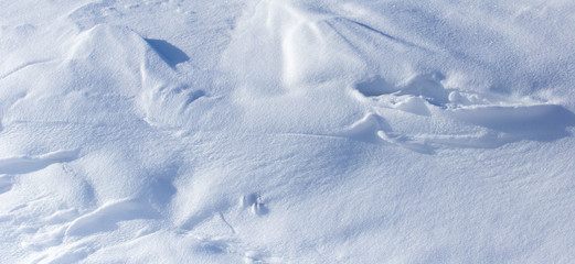 White snow on the mountainside as a background