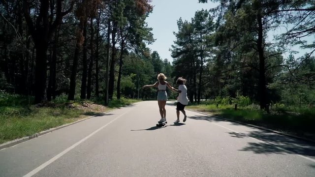 guy teaches girl to skate.