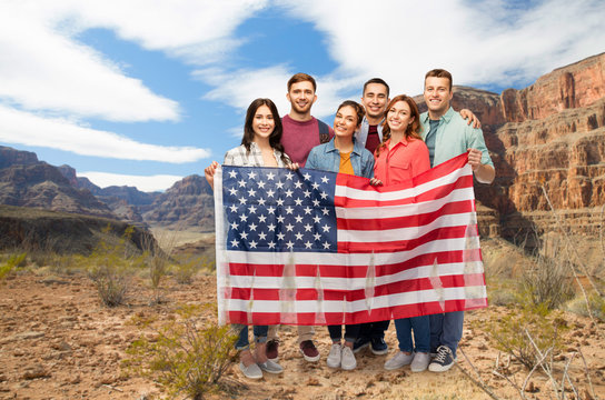 patriotism, citizenship and national concept - group of smiling friends with american flag over grand canyon background