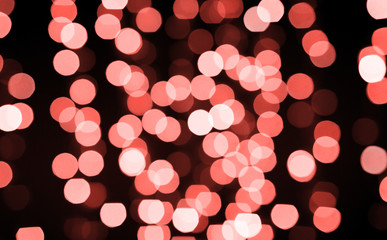 holidays and design concept - blurred bokeh lights in living coral, color of the year 2019 © Syda Productions