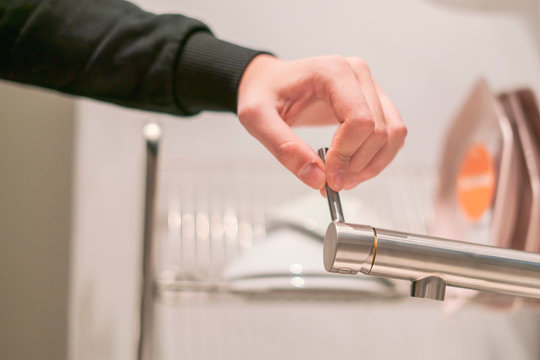 Hand Opens The Kitchen Water Faucet Tap Close Up F