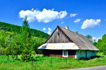 Fototapeta na wymiar Old wooden rural hause beside country road, Low Beskids (Beskid Niski), Poland 