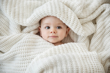 Close up of baby girl wrapped in blanket