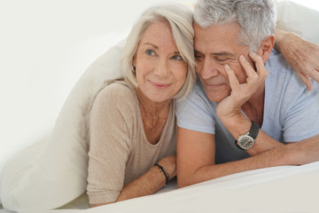  Portait of happy attractive senior couple in bed