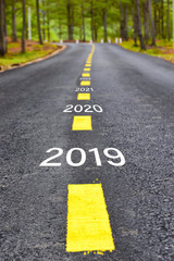 Number of 2019 to 2023 on asphalt road surface with marking lines, happy new year concept