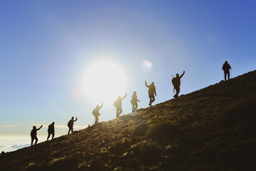 hiking activity and successful climbers on the summits of the mountains