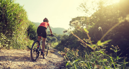 Woman cyclist riding a bike on a nature trail in the mountains.people living a healthy lifestyle