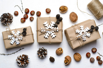 Christmas Gifts, Nuts, Pine Cones on White Background, Nacural Decor Materials, Winter Holidays Concept