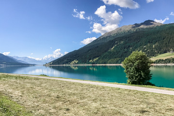 blue smooth lake on a background of mountains, the view from the shore