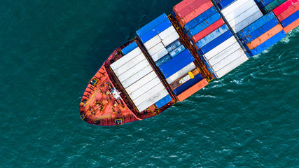 Fototapeta na wymiar Aerial view cargo container ship carrying container for import and export, business logistic and freight transportation by ship in open sea.