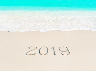 Year 2019 season concept on azure ocean tropical beach sand