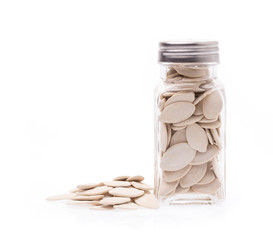 Pumpkin seeds in bottle isolated on the white background