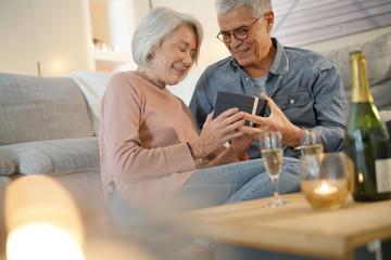  Modern senior couple exchanging gifts at home