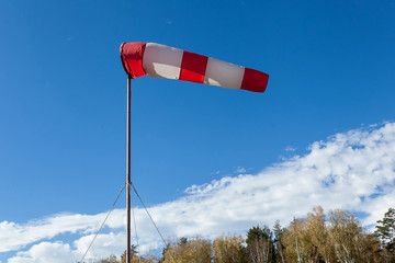 Airport windsock on clear blue sky background in windy weather indicate the local wind direction...