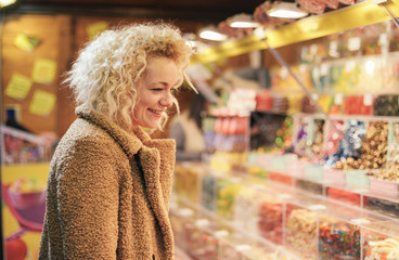 Pretty woman on a Christmas market smiling