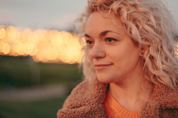 Portrait of a pretty woman with new year decorations and lights