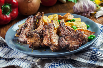 Roasted lamb chops served with baked potatoes