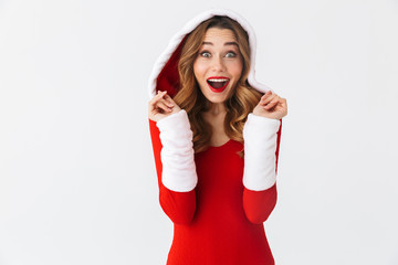 Image of festive girl 20s wearing Christmas red dress standing, isolated over white background