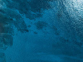 Sea surface arial view with visible coral reef