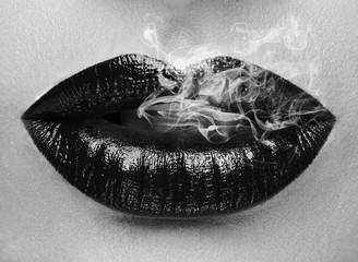 Sexy woman smoking closeup black and white.