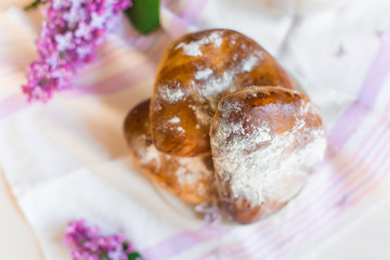 Delicious bakery cakes, buns with jam and violet flowers. Food and spring concept