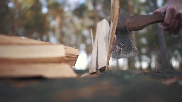 Axe chopping a log close up. Wood chopping. Slow motion.