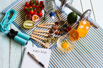 Ketogenic diet meal plan with Workout and fitness dieting ,fitness and weight loss concept, fruit,Vegetable and orange juice,salad,top view and notebook on wooden background, Food and health.