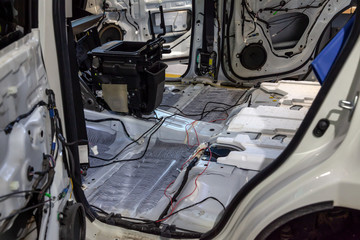 Fully dismantled interior elements of the car in a white crossover, removed the trim from the side doors, installation of sound insulation inside.