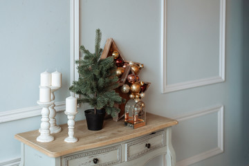 Elements of Christmas decor. A small tabletop tree and Christmas decorations.
