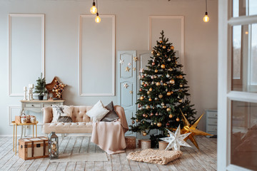 Bright cozy living room with a large elegant Christmas tree, decorated for Christmas