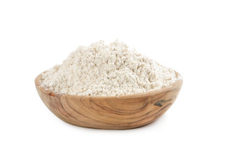 Whole wheat flour in wooden bowl isolated on white