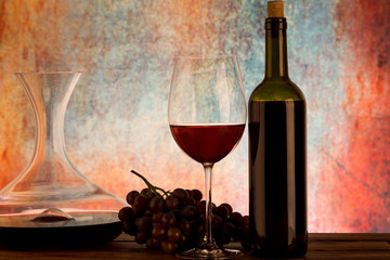 Glass and bottle of red wine decanter on table