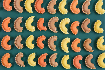 Pasta creste di gallo on green background