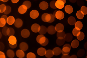 Abstract background. Orange circles on a black background.