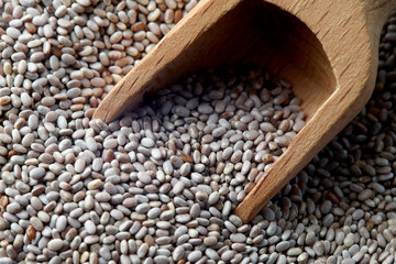 Close up of white chia seeds with wooden scoop