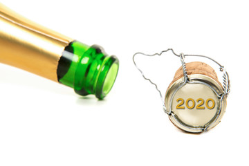 Champagne bottle and cork and with new year 2020 on the cork on a white background