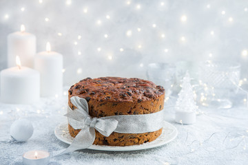 Traditional Christmas fruit cake on festive background